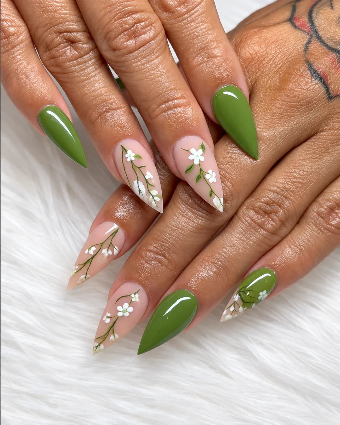 Almond-shaped nails in olive and nude with hand-painted floral art